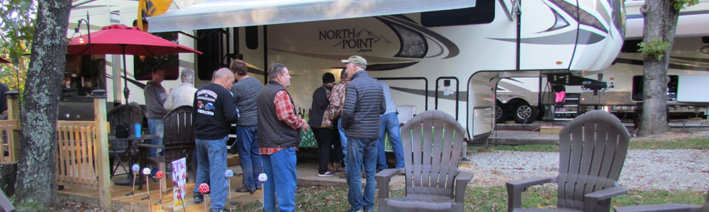 An RV parked at a campground who uses the Campground Commander Manage and Campground Commander Reserve apps